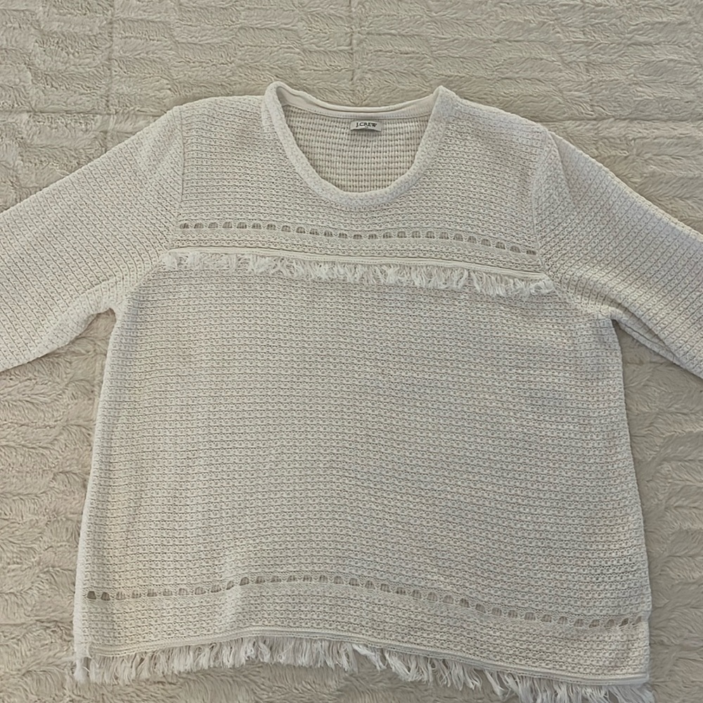 J crew white sweater. Size is cutout but I would guess a large